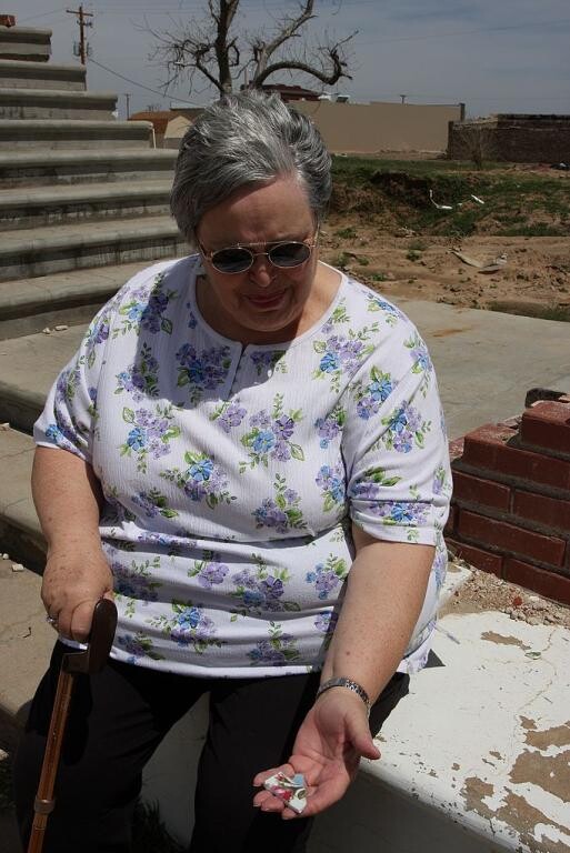 56. Woman sitting on steps of destroyed church, Greensburg, Day 4
